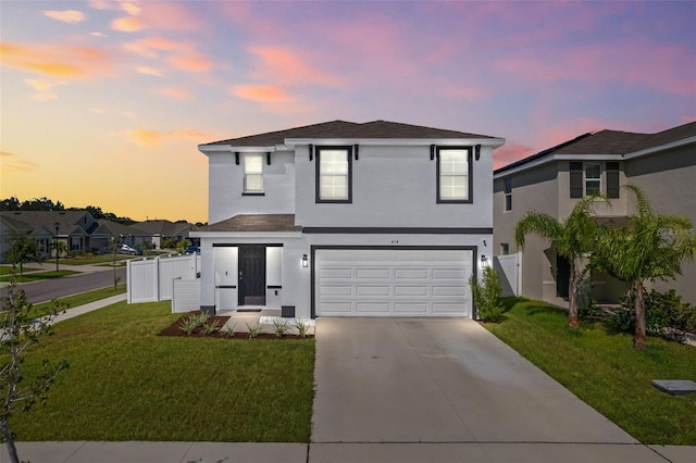 view of front facade with a yard and a garage