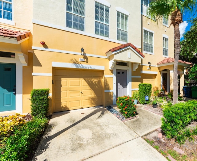 townhome / multi-family property featuring a garage