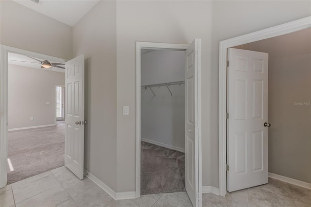 bathroom with ceiling fan and tile patterned flooring