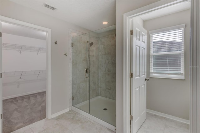 bathroom featuring tile patterned flooring and walk in shower