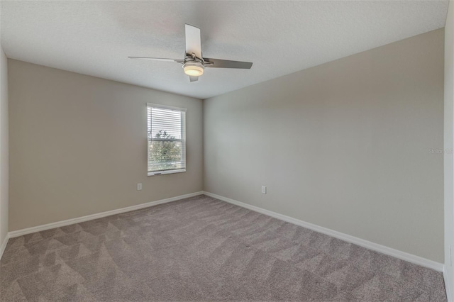 spare room with light carpet and ceiling fan