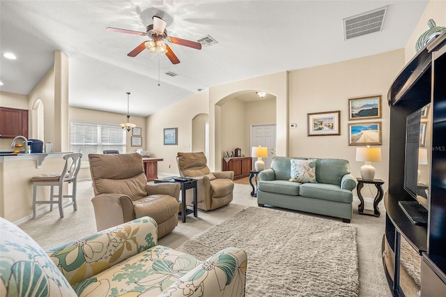 living room with ceiling fan, light colored carpet, lofted ceiling, and sink