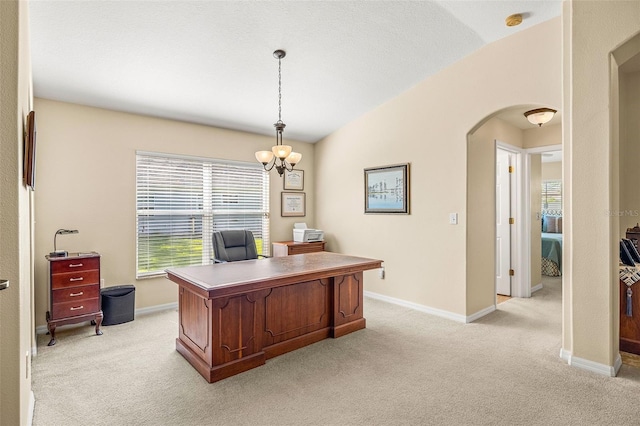 carpeted office featuring a notable chandelier and vaulted ceiling