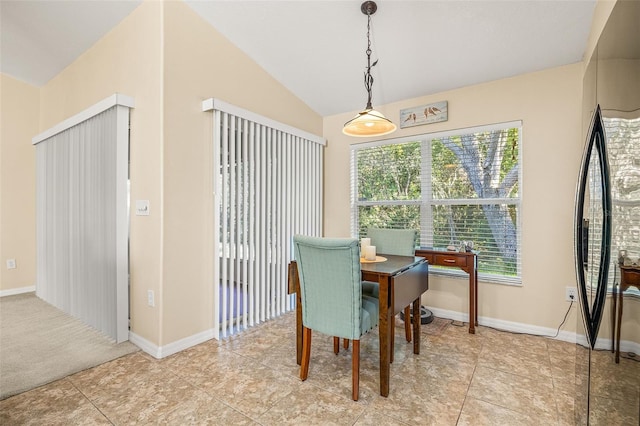 tiled dining space featuring vaulted ceiling