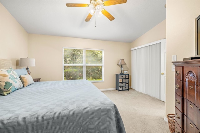 bedroom featuring ceiling fan, light colored carpet, and lofted ceiling