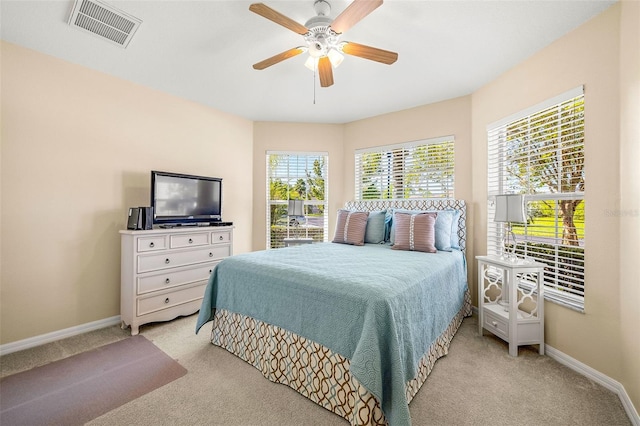 bedroom with ceiling fan and light colored carpet