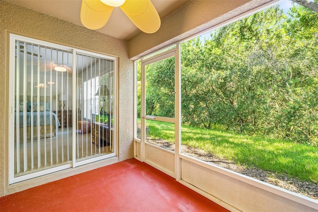 unfurnished sunroom with ceiling fan