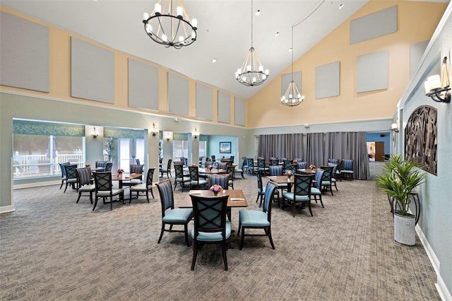 carpeted dining room featuring a notable chandelier and high vaulted ceiling