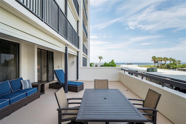 view of patio featuring a balcony, an outdoor hangout area, and a water view