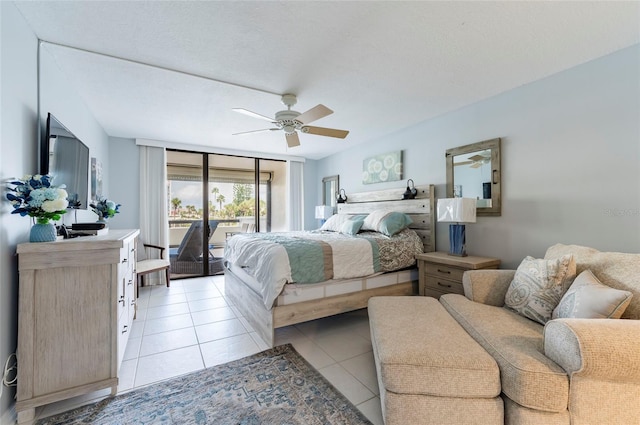 bedroom featuring ceiling fan, access to exterior, light tile patterned flooring, and a textured ceiling