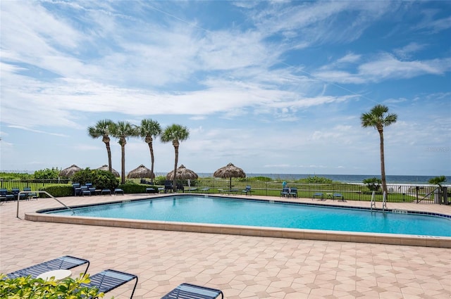 view of swimming pool with a water view