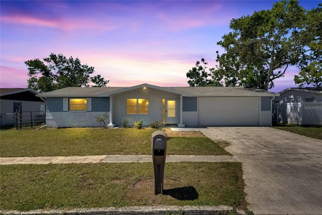 ranch-style home with a yard and a garage