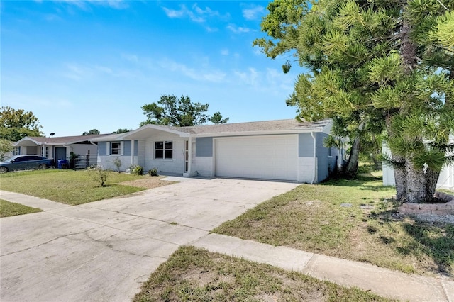 ranch-style home with a garage and a front lawn