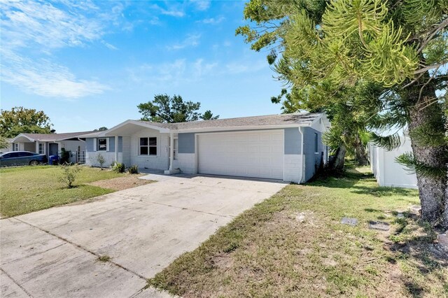 single story home with a front yard and a garage