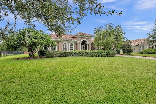 mediterranean / spanish house featuring a front lawn