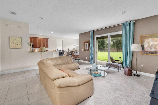 tiled living room with a textured ceiling