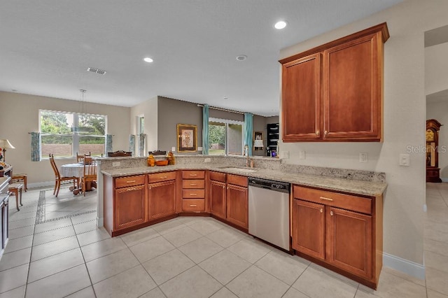 kitchen with light tile patterned flooring, sink, kitchen peninsula, hanging light fixtures, and stainless steel dishwasher