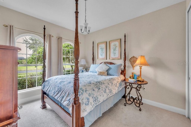 bedroom featuring light colored carpet and an inviting chandelier