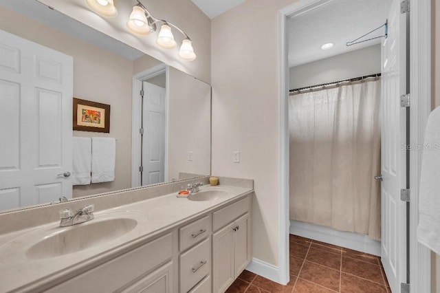 bathroom with vanity, tile patterned flooring, and curtained shower