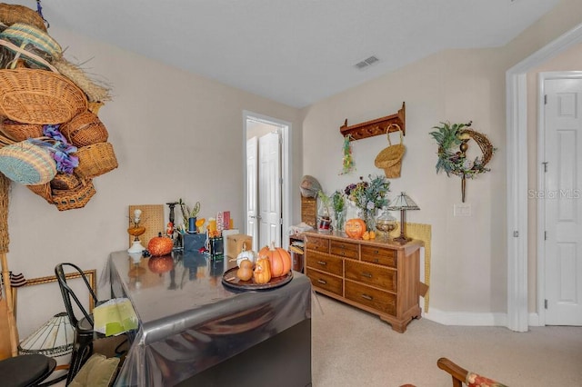 dining space with light colored carpet