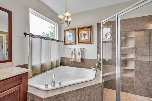 bathroom featuring a chandelier, vanity, and separate shower and tub