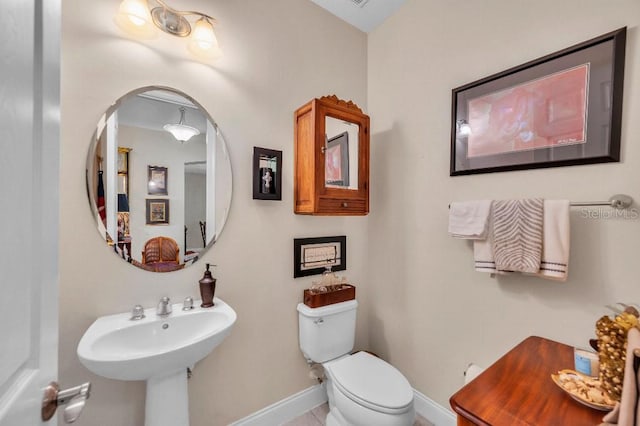 bathroom with tile patterned flooring and toilet