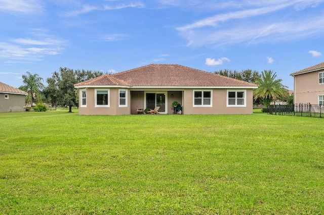 rear view of property with a lawn