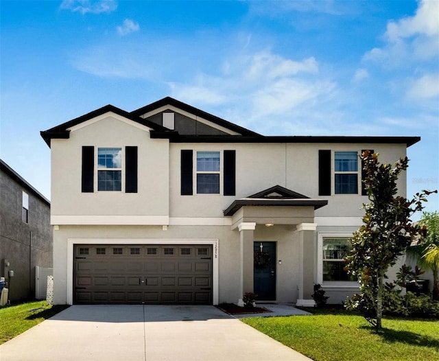 view of front of property with a garage and a front lawn