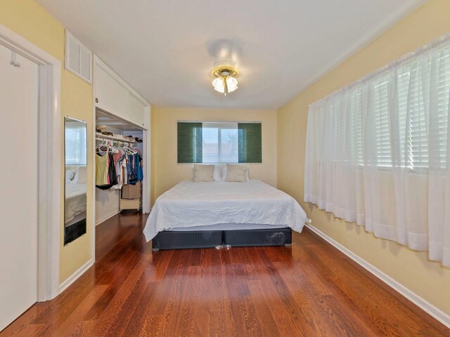 bedroom featuring a closet and dark hardwood / wood-style flooring