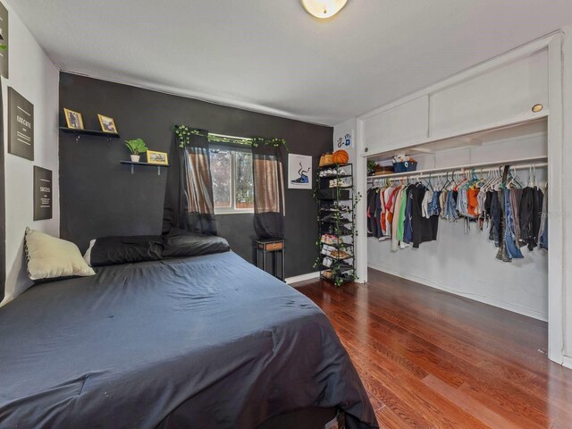 bedroom with a closet and hardwood / wood-style flooring