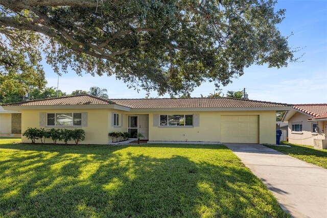 single story home featuring a front yard and a garage