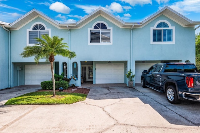 multi unit property featuring a garage