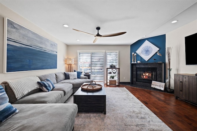 living room featuring ceiling fan and dark hardwood / wood-style floors