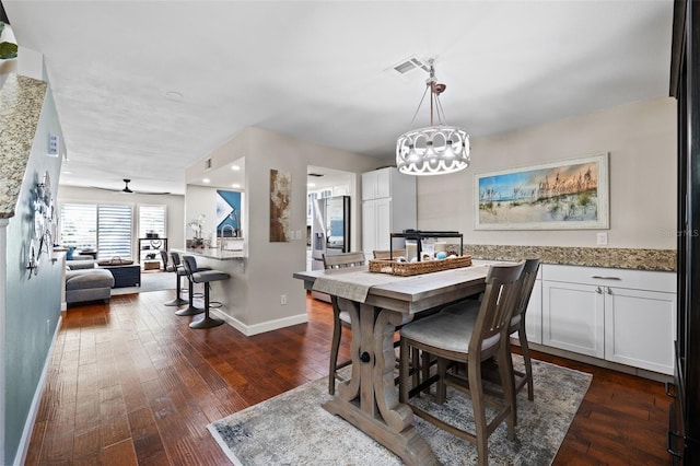 dining space featuring ceiling fan and dark hardwood / wood-style floors