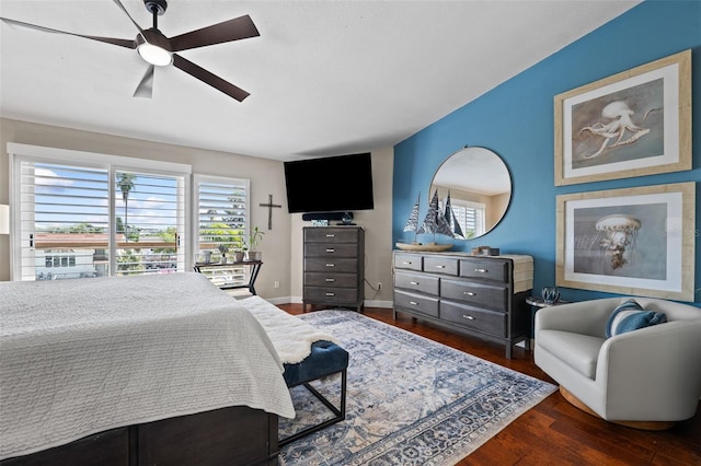 bedroom featuring multiple windows, dark hardwood / wood-style floors, and ceiling fan