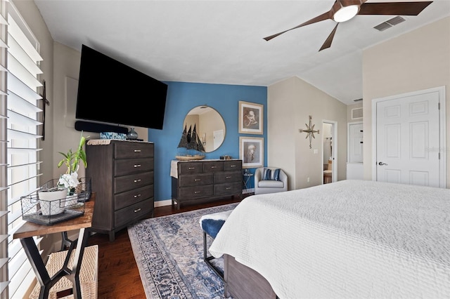 bedroom with lofted ceiling, ceiling fan, multiple windows, and dark wood-type flooring