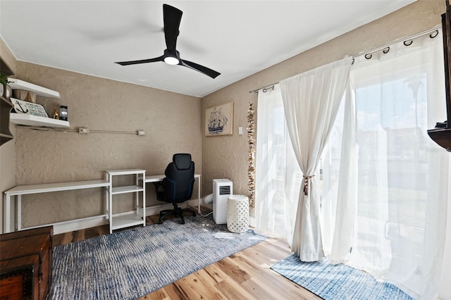 office space featuring wood-type flooring and ceiling fan