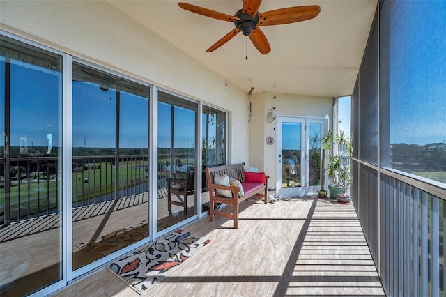 sunroom featuring ceiling fan