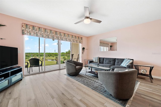 living room featuring ceiling fan and hardwood / wood-style flooring