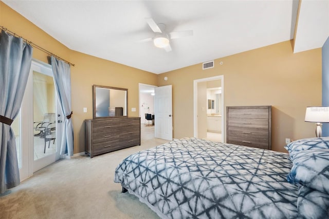 carpeted bedroom featuring ensuite bath and ceiling fan