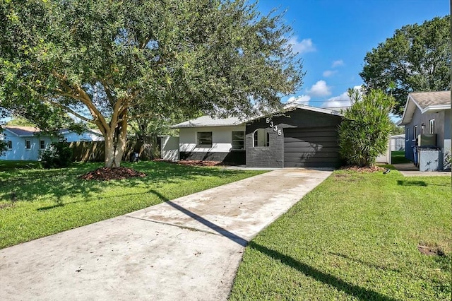 ranch-style home featuring a front yard and a garage