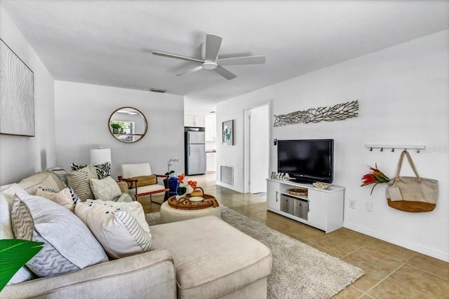 living room with ceiling fan and tile patterned flooring