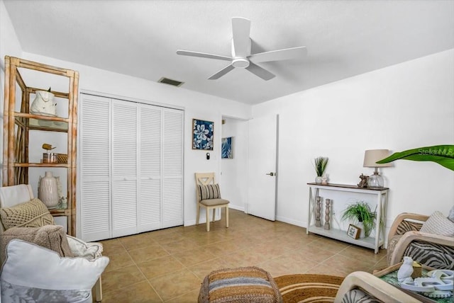 interior space with light tile patterned floors and ceiling fan