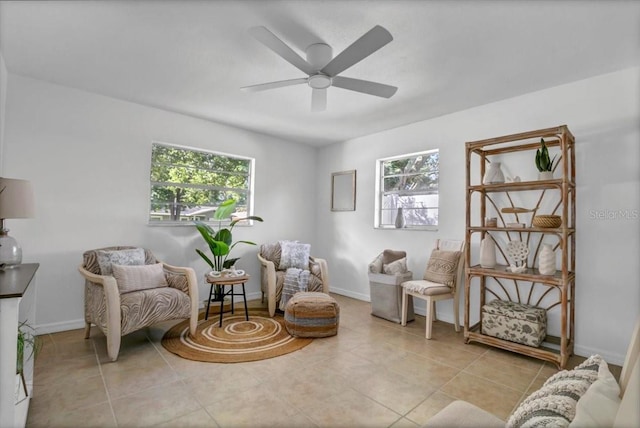 sitting room featuring ceiling fan and light tile patterned floors