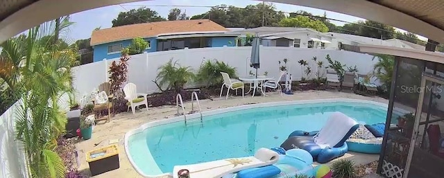 view of swimming pool with a patio area