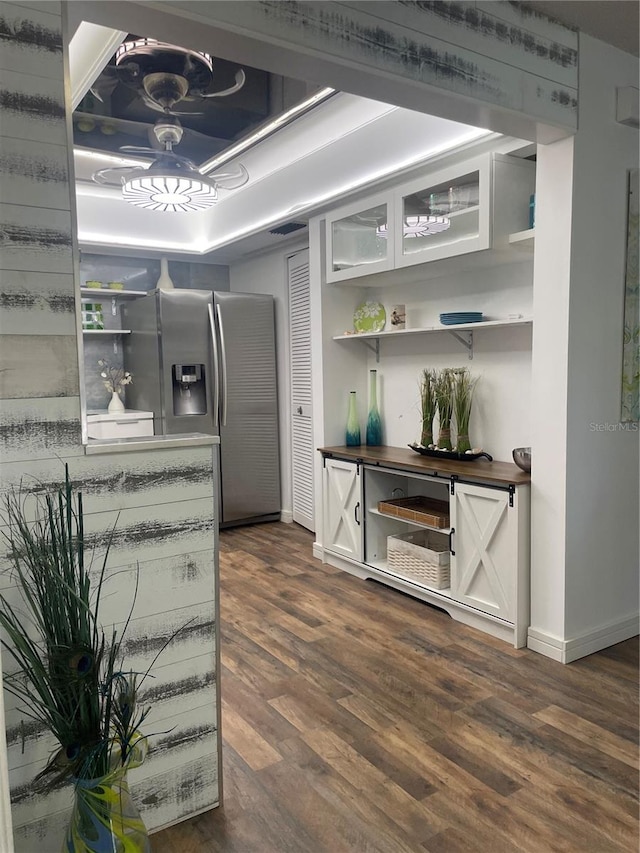 kitchen with stainless steel fridge and dark hardwood / wood-style flooring