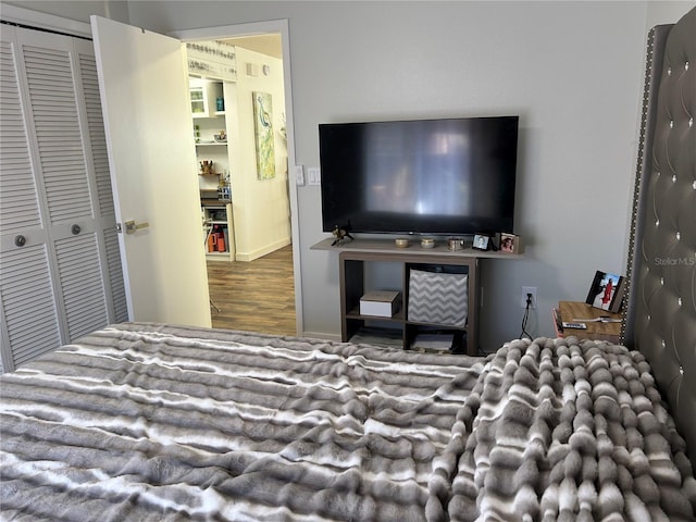 bedroom with hardwood / wood-style flooring and a closet