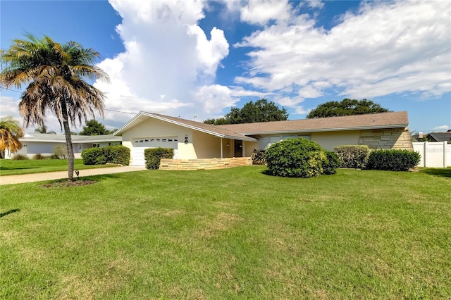 ranch-style home featuring a front lawn and a garage