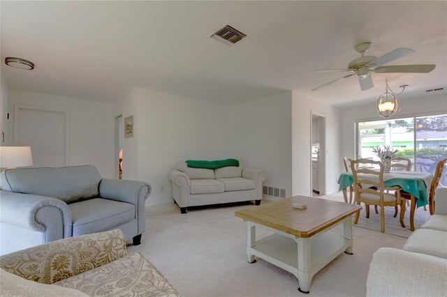 carpeted living room featuring ceiling fan