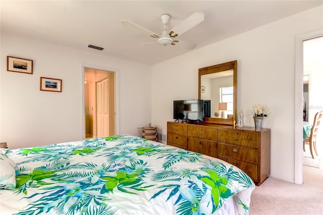 bedroom featuring light carpet, a closet, and ceiling fan